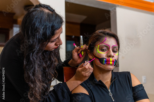 woman putting makeup on another woman