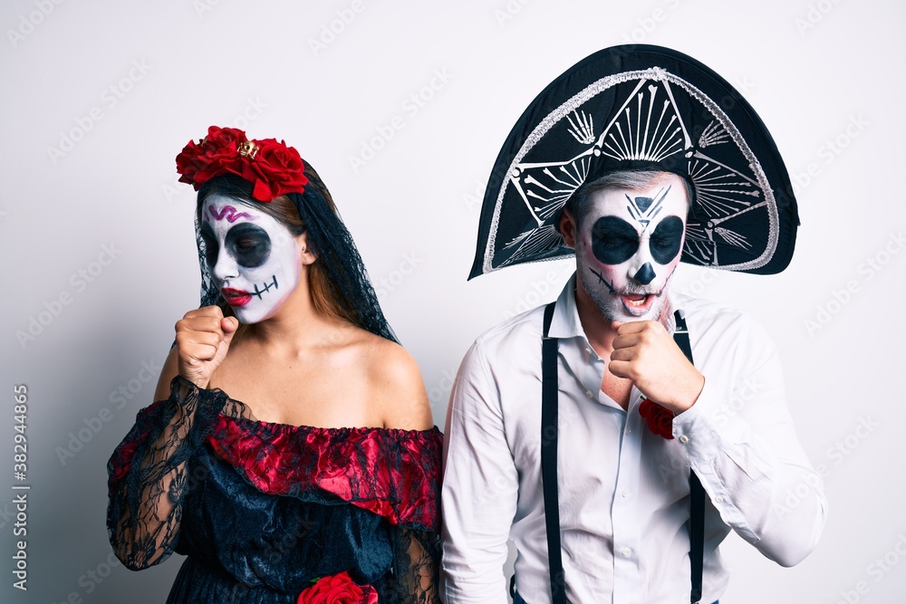 Couple wearing day of the dead costume over white feeling unwell and coughing as symptom for cold or bronchitis. health care concept. Couple wearing day of the dead costume over white feeling unwell and coughing as symptom for cold or bronchitis. health care concept.