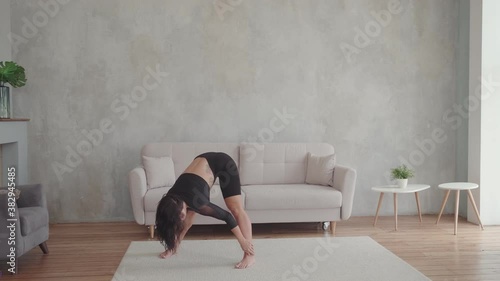 A young woman is doing a stretch. photo