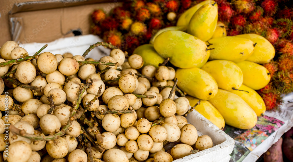 Lanzones, Yellow Mangoes and Rambutan for sale at a local market in the