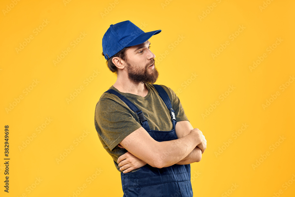 man in work uniform rendering service forklift work lifestyle yellow background