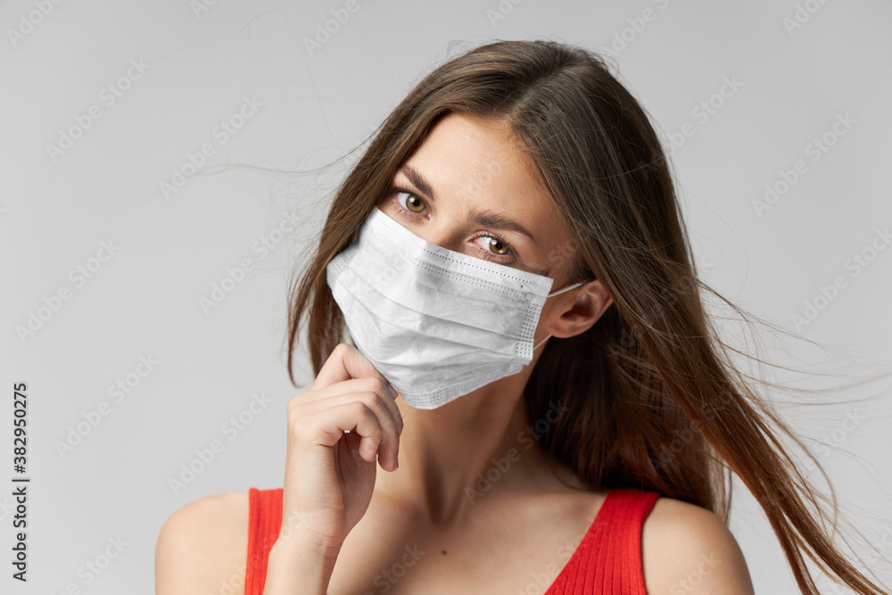 woman wearing medical mask looking ahead lifestyle close-up red t shirt woman wearing medical mask looking ahead lifestyle close-up red t shirt