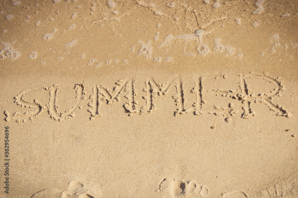 Fototapeta premium Inscription summer and incoming sea wave on sand at beach. Travel and vacation time