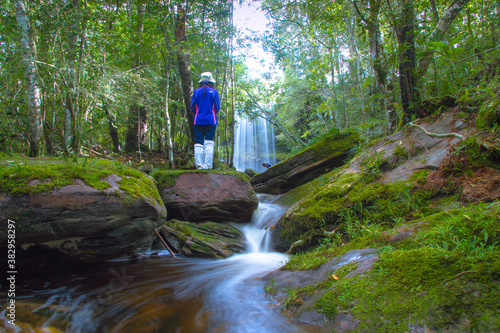 person in the waterfall forest at Phukradung national park of Thailand photo