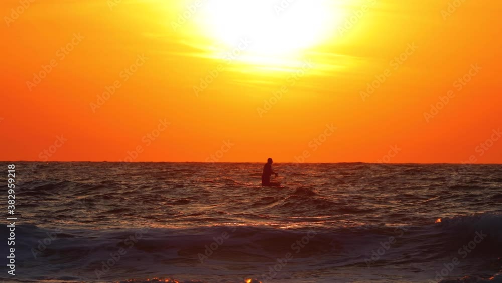 Ocean sunrise. Fisherman sailing with boat on ripple waves Ocean sunrise. Fisherman sailing with boat on ripple waves