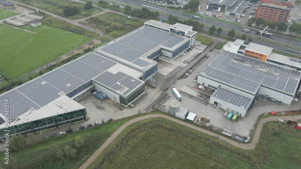 Aerial view of busy industrial terrain with solar panels on rooftop Aerial view of busy industrial terrain with solar panels on rooftop