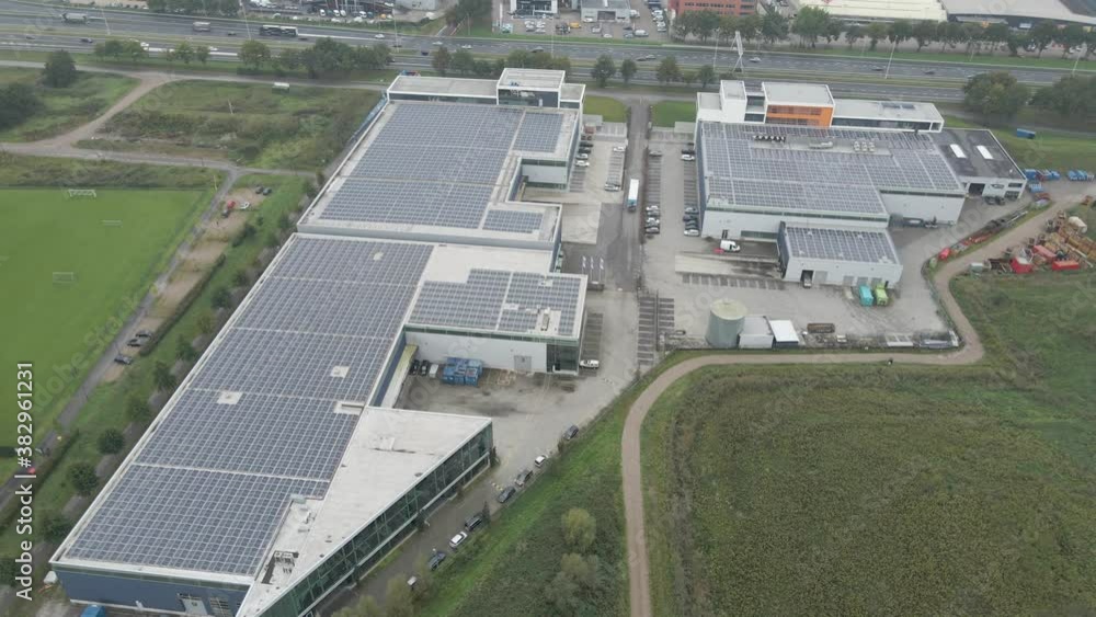 Aerial overview of busy industrial terrain with solar panels on rooftops Aerial overview of busy industrial terrain with solar panels on rooftops