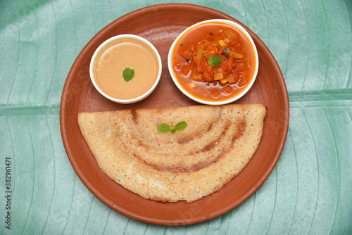 Dosa, ghee roast, coconut chutney and sambar popular South Indian Breakfast, Kerala, Tamil Nadu India. Top view of Masala dosa, pancake stuffed with potato, tomato curry side dish. Vegetarian food. photo