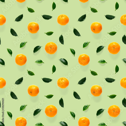 Mandarine seamless pattern, tangerine, clementine isolated on green background with green leaves. Collection of fine seamless patterns.