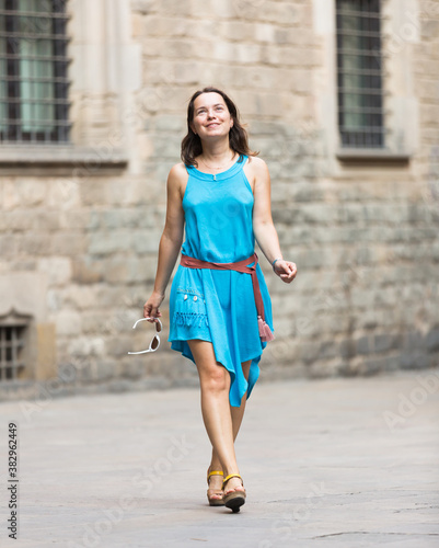 Portrait of handsome smiling woman posing on urban streets in Europe