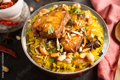 Fish biryani. Spicy Indian Malabar biryani or Hydrabadi biryani, Dum Biriyani, fish and rice. pulao basmati rice, spicy mixed rice dish with meat curry for Ramadan Kareem, Eid
