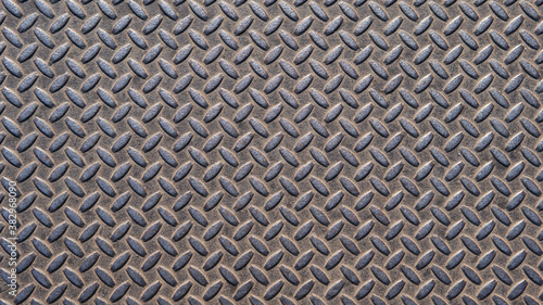 A metal plate with a seamless repeating pattern. Abstract metallic background. An interesting steel pattern for your projects.