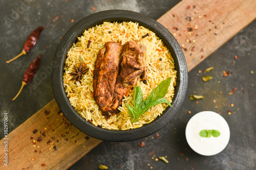 Arabic chicken Manthi or mandi  cooked meat, Basmati rice with Masala, spice. Kuzhimanthi or hot and spicy Manthi on black background in Malabar Kerala,  South India. Top view of  Indian non veg food. photo