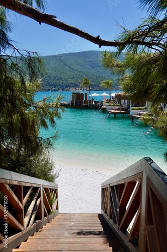 Stairs to the Paradise. Advertising holiday banner Lux. Stairs descend to a very beautiful protected beach with white sand and pure emerald water. CLOSE UP: Scenic stairwell offers a breathtaking view
