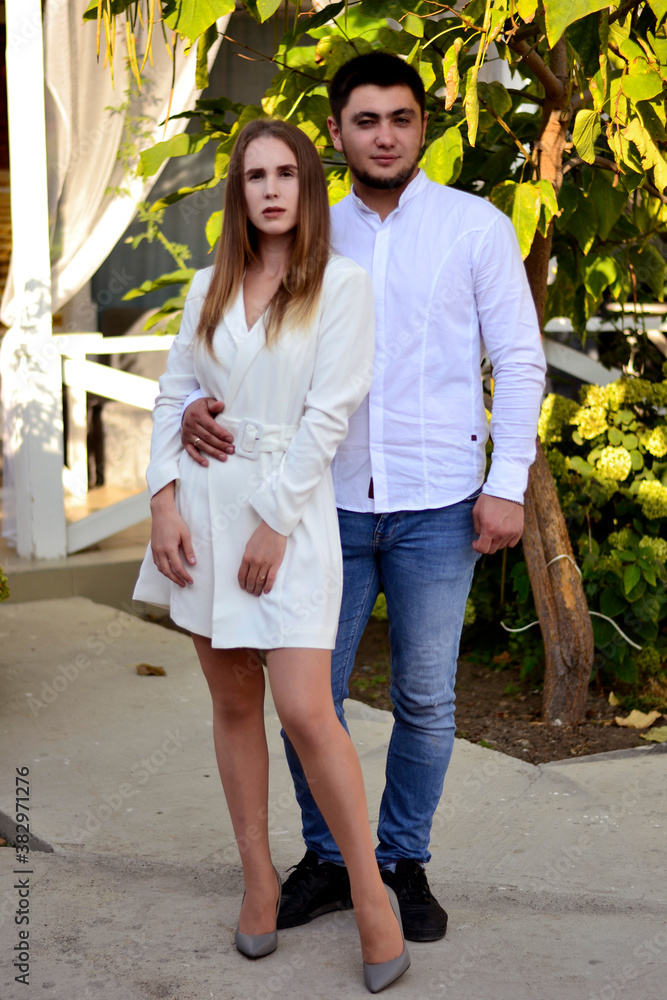 Young guy with a girl in white clothes
