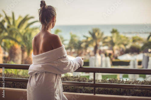 Young woman standing on the balcony