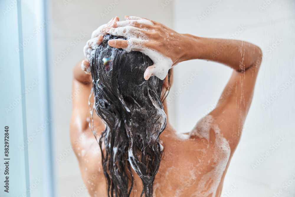 Young woman washing her hair in shower - obrazy, fototapety, plakaty 