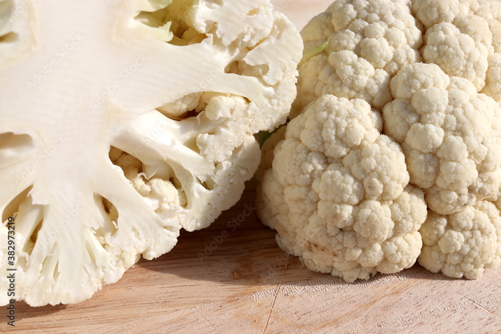 Cauliflower on wooden chopping board Cauliflower on wooden chopping board