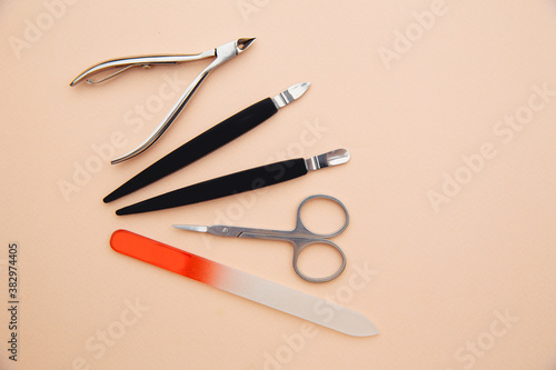 Tools of a manicure set on a pink background. Nail care concept.