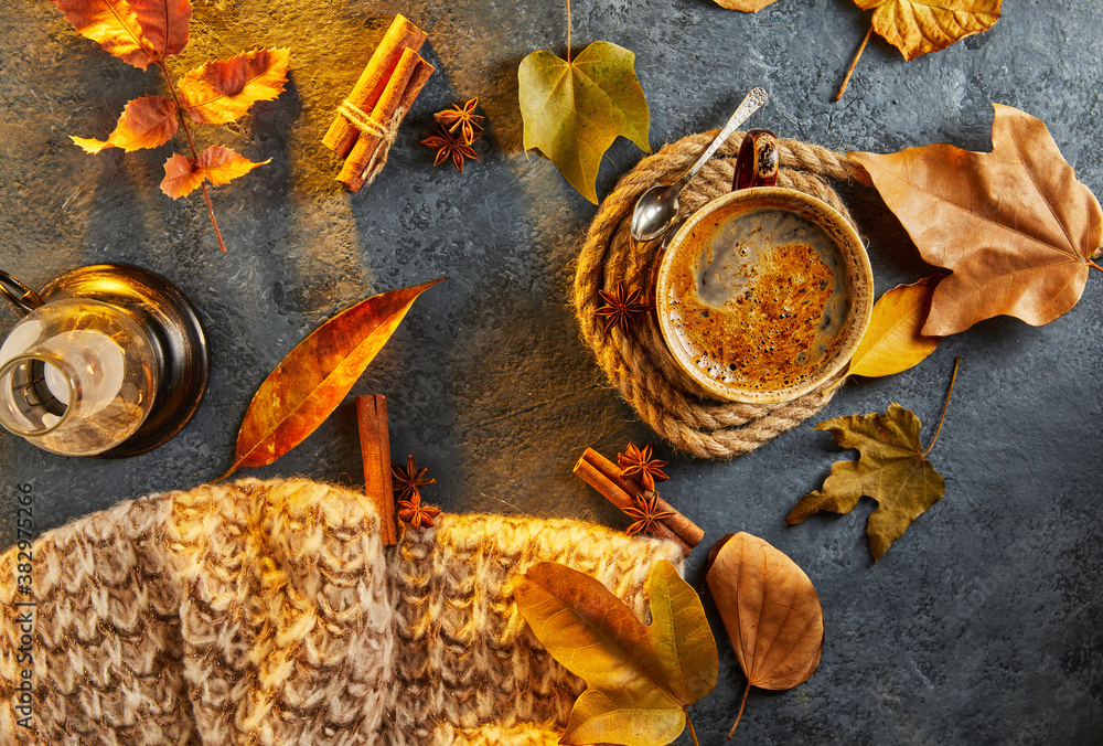 Autumn, fall leaves, a hot steaming cup of coffee and a warm scarf against the background of a blue table. Seasonal, morning coffee, sunday relaxation and still life concept Autumn, fall leaves, a hot steaming cup of coffee and a warm scarf against the background of a blue table. Seasonal, morning coffee, sunday relaxation and still life concept