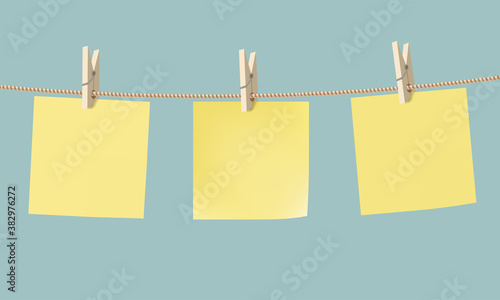 Yellow paper stickers hang on a rope with a clothespin