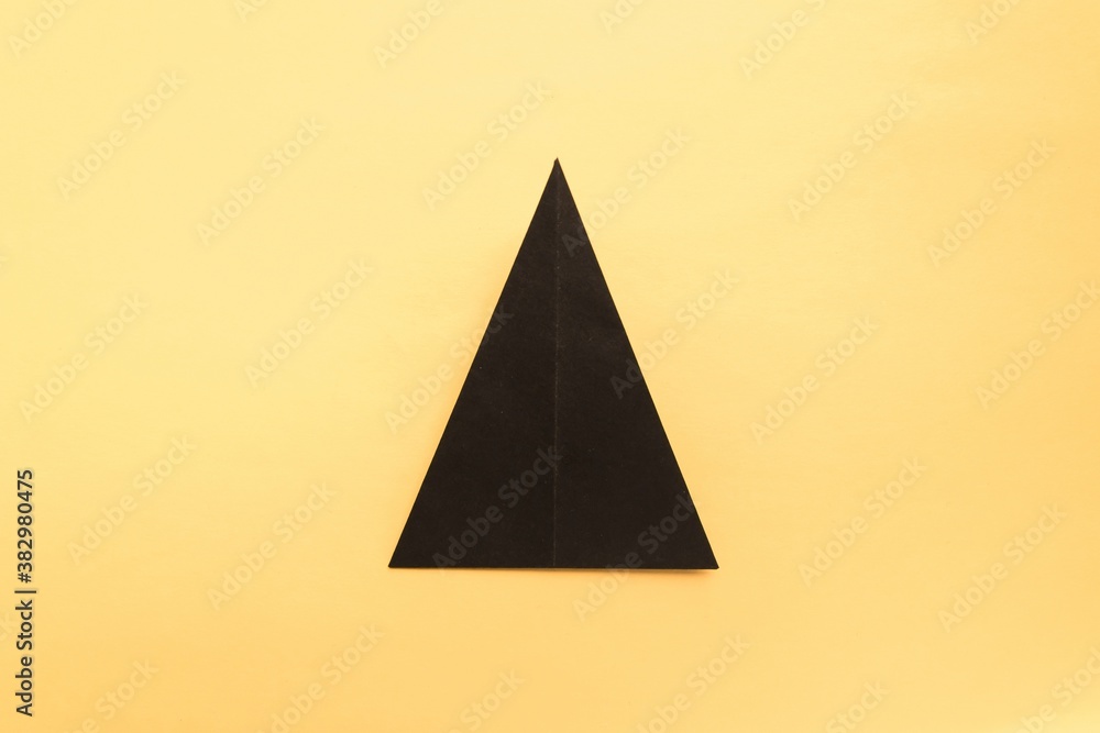 Fototapeta premium Step by step photo instruction how to make origami paper hat. Halloween hat of witch. Simple diy with kids children's concept.