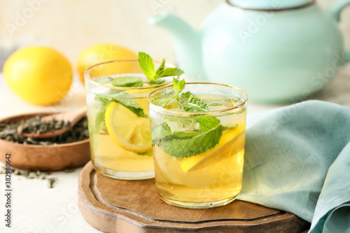 Glasses of tasty cold ice tea on table