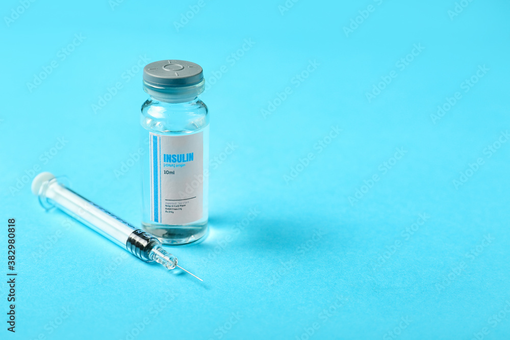 Bottle of insulin with syringe on color background. Diabetes concept Bottle of insulin with syringe on color background. Diabetes concept