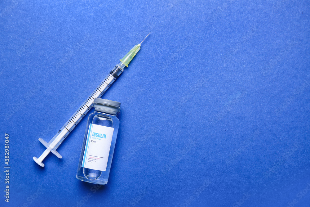 Bottle of insulin with syringe on color background. Diabetes concept Bottle of insulin with syringe on color background. Diabetes concept
