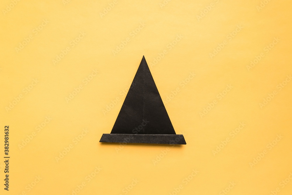 Fototapeta premium Step by step photo instruction how to make origami paper hat. Halloween hat of witch. Simple diy with kids children's concept.