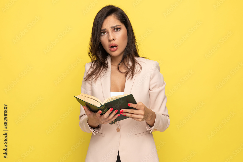shocked young businesswoman in pink reading book shocked young businesswoman in pink reading book
