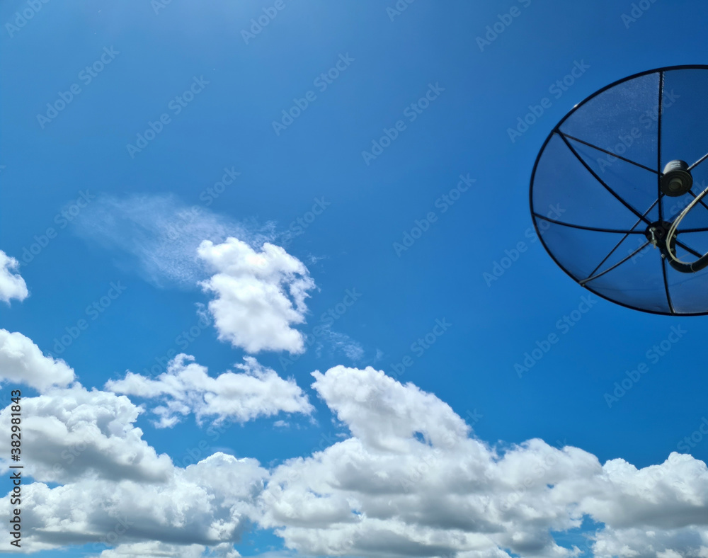 The sky with bright clouds and a satellite dish