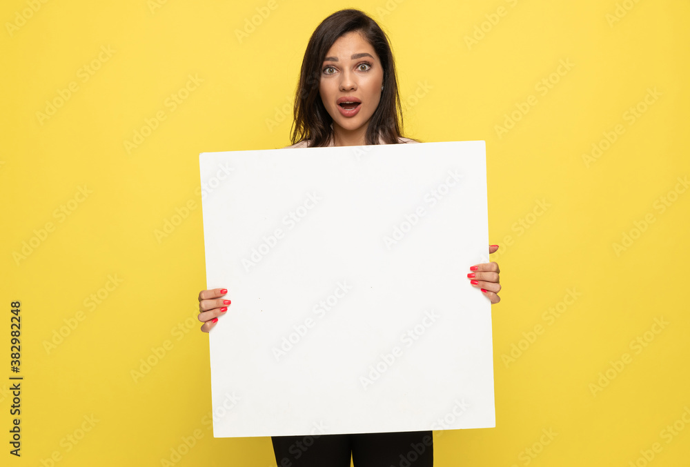shocked young businesswoman holding empty board shocked young businesswoman holding empty board