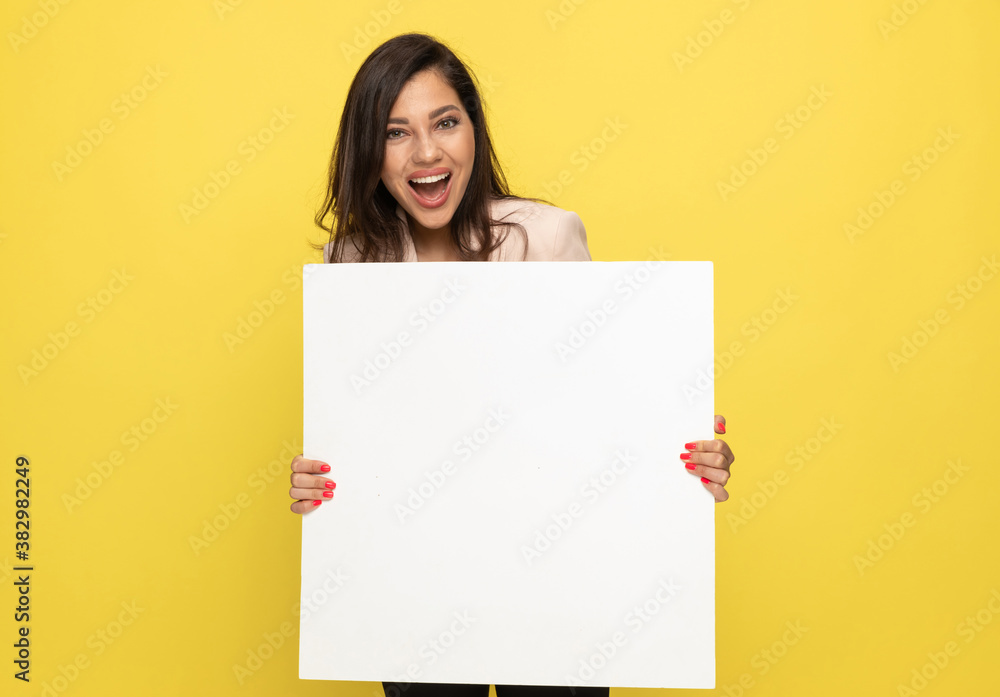 excited young businesswoman holding empty board excited young businesswoman holding empty board