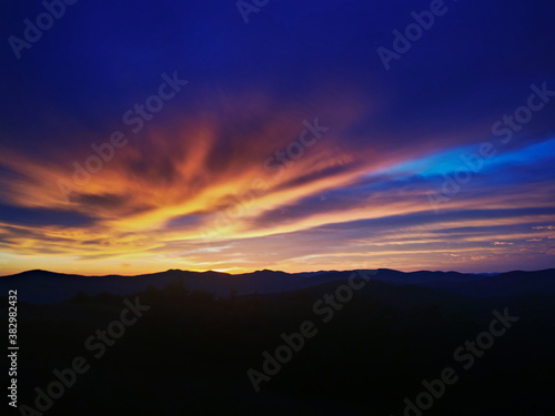 Red sunrise at the top of the mountain. Sunrise in the Bieszczady mountains Carpathians. Outline of the mountains. © Tomek