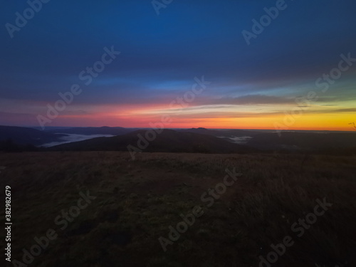 Red sunrise at the top of the mountain. Sunrise in the Bieszczady mountains Carpathians. Outline of the mountains.