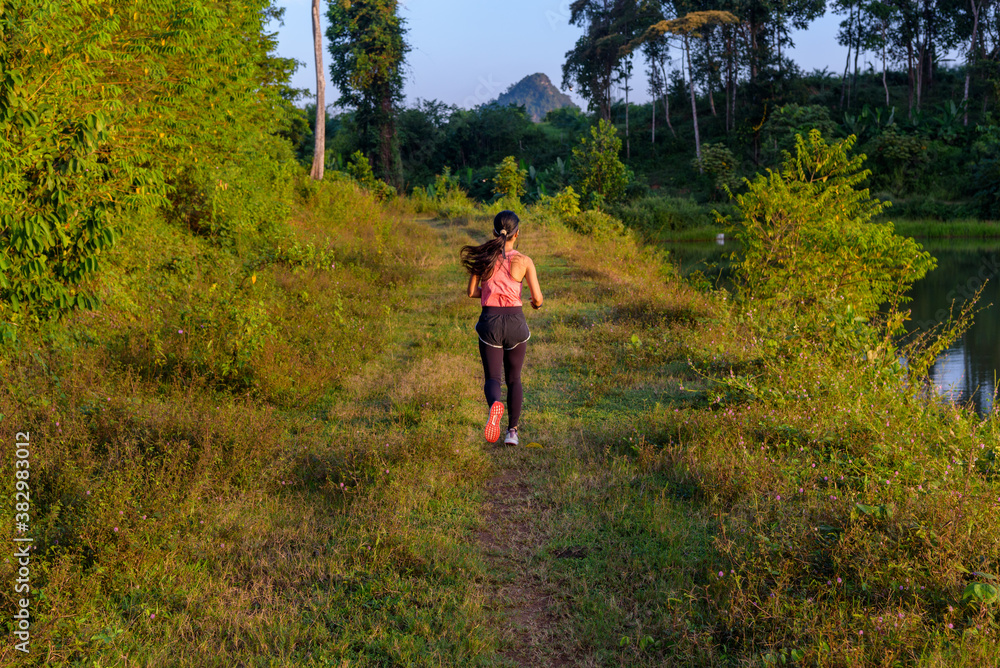 A woman trail runner practices in the morning. Active lifestyle