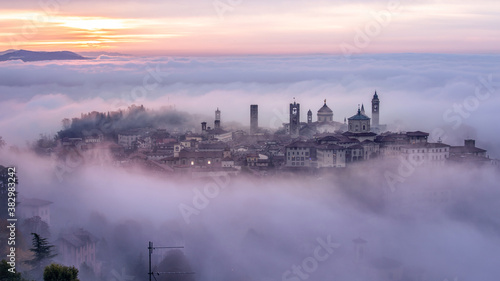  Bergamo Città Alta shrouded in fog on a foggy winter morning, this is the oldest part of medieval Bergamo, Lombardy, Italy.