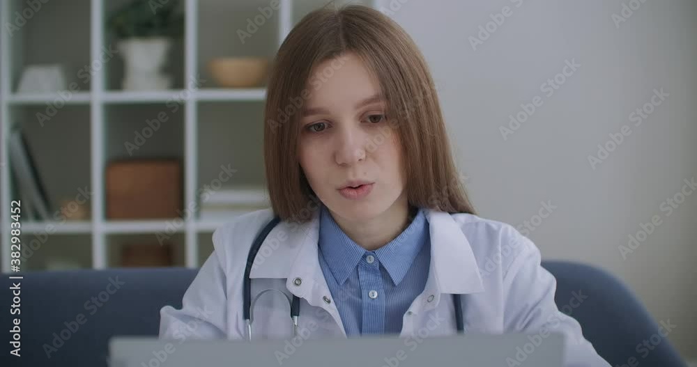 consultation of doctor by telephone, female physician is answering on questions of patients in call-center, profile view consultation of doctor by telephone, female physician is answering on questions of patients in call-center, profile view