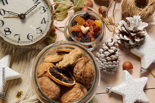 christmas decoration in rustic style and holiday background, still life on wooden backdrop, bread, nuts and other