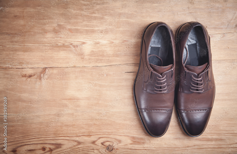 Brown shoes on the wooden background. Brown shoes on the wooden background.