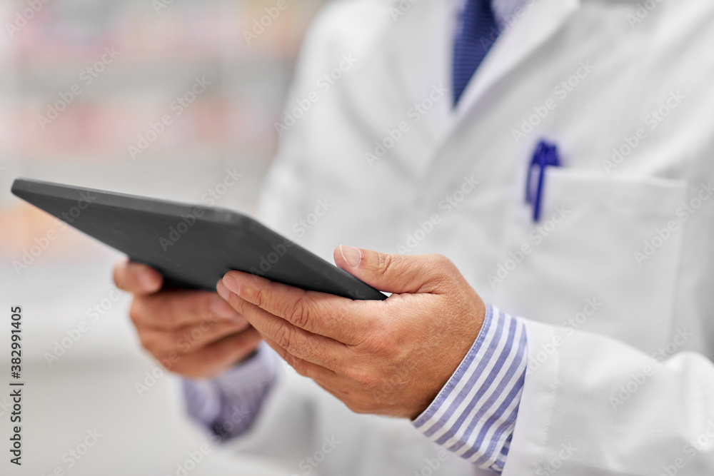 medicine, healthcare and technology concept - close up of senior pharmacists with tablet pc computer at pharmacy medicine, healthcare and technology concept - close up of senior pharmacists with tablet pc computer at pharmacy