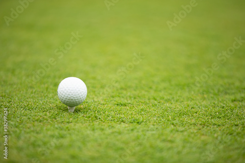 Illustration of a golf ball on a green meadow