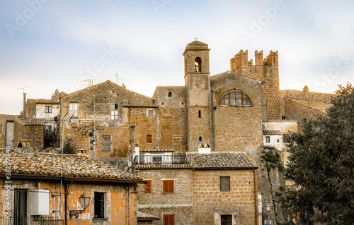 View of medieval towers and walls of the commune town of Calcata in Italy depopulated in 1930th for fear of collapse and then repopulated by artists and hippies in 1960th photo