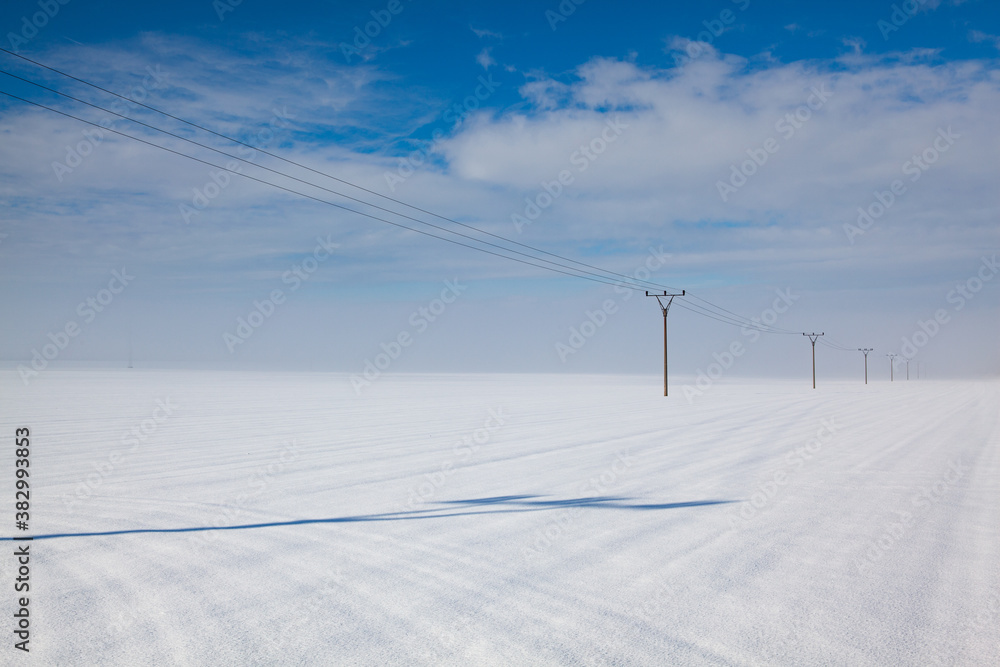 Winter landscape with power line columns Winter landscape with power line columns