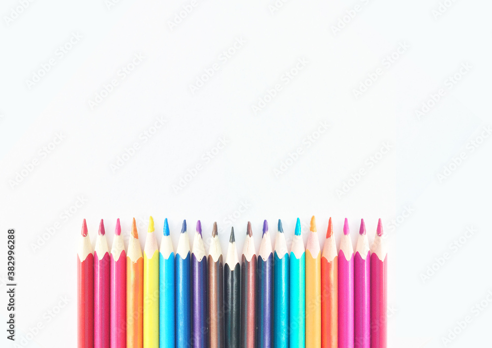 Colored pencils on white paper, pencils around the edges of the paper, mockup, school supplies, Colored pencils on white paper, pencils around the edges of the paper, mockup, school supplies,