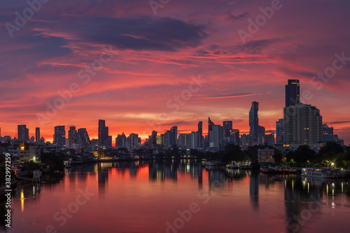 Bangkok city center financial business district, waterfront cityscape and Chao Phraya River during twilight before sunrise, Thailand