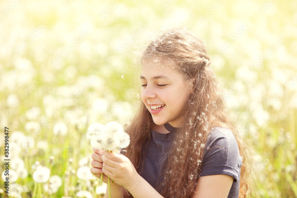 girl play in a field with dandelions, summer day girl play in a field with dandelions, summer day