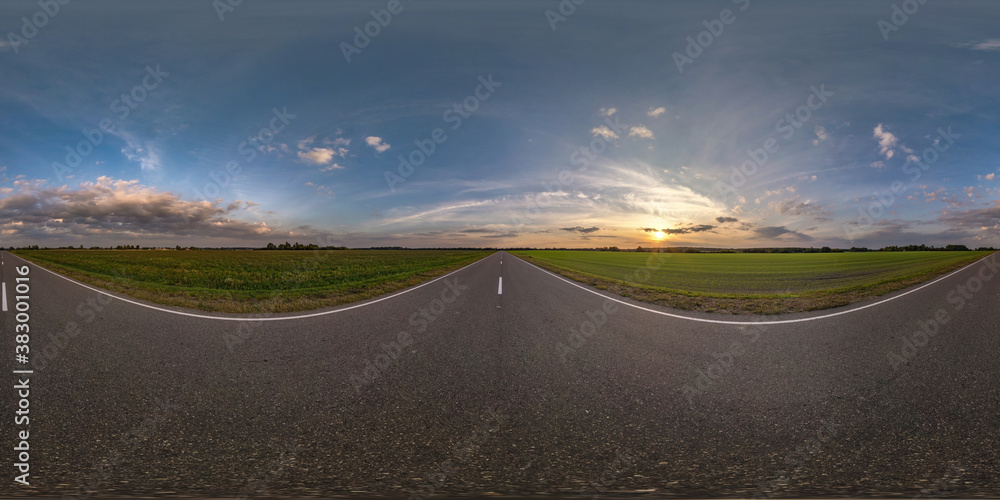 Full spherical seamless panorama 360 degrees angle view on no traffic old asphalt road among fields with evening sky and beautiful clouds in equirectangular projection, VR AR content