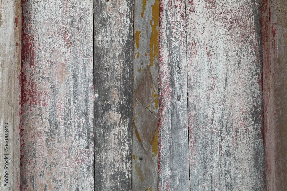 Fototapeta premium Old wooden door For more than eighty years in the sun and for a long time it is deteriorating with time and the color is peeling off the wood.